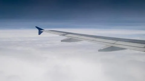 The airplane wing on the sky. Stock Photos