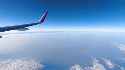 Airplane Wing Soaring Over Fluffy White Clouds Resembling Snowy Landscape Stock Footage 310733064