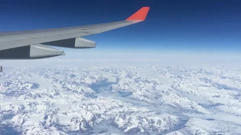Airplane Wing Soaring Over Vast Snowy Mountain Range. Stock Footage 321179919