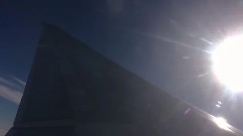 Airplane wing sun flare outside window Stock Footage 77809406