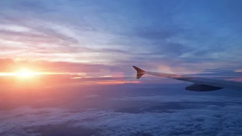 Airplane Wing at Sunset Above the Clouds, Aerial View Stock-Footage 310376942