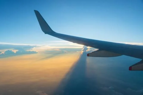 Airplane wing at sunset Stock Photos