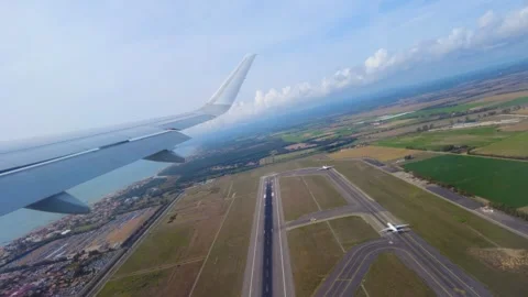 Airplane wing sweeps active runway complex taxiways during departure patchwork Stock Footage 326355506