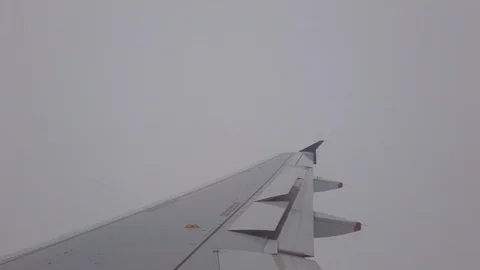 Airplane wing in thick zero visibility clouds Stock Footage 112368914
