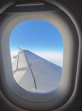 Airplane wing through the window Stock Photos