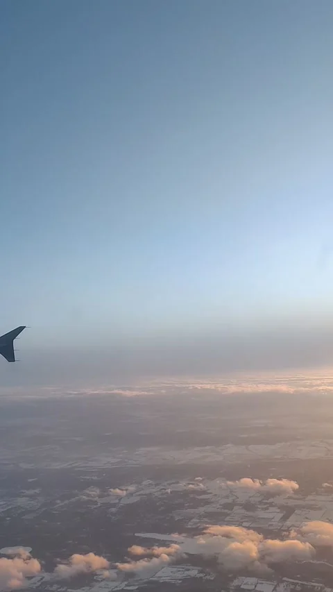 Airplane Wing Tip  Descending Through Clouds at Sunset Stock Footage 168905769