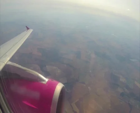 Airplane wing turbine, maximum height kilometers below land, air, click for HD Stock Footage 43966436