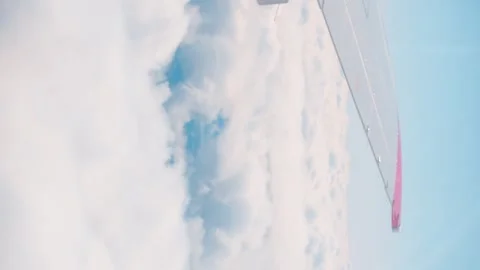 Airplane wing vertical video thick clouds spectacular scene Airplane wing marvel Stock Footage 263699497