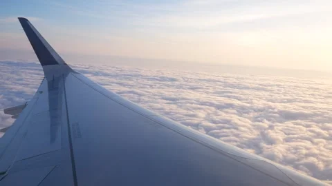 Airplane Wing View Above the Clouds at Sunset Stock Footage 268651022