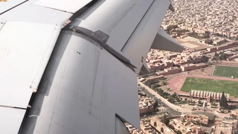 Airplane wing view approaching Marrakech airport with the city visible in th Stock Footage 339353163