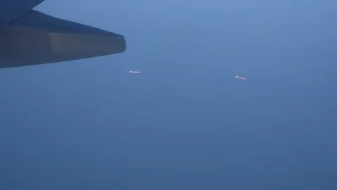 Airplane wing view of distant lights in foggy sky during twilight hours Stock Footage 328916245