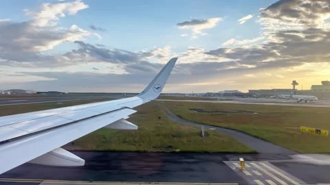 Airplane wing view during runway taxi at Frankfurt Airport before departure Stock Footage 340139336