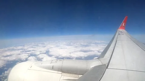 Airplane wing view flying high above a dense sea of white clouds Stock Footage 337060658