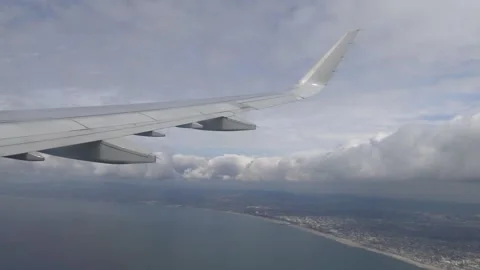 Airplane Wing View Leaving Los Angeles Coastline Over the Pacific Ocean Stock Footage 321583248