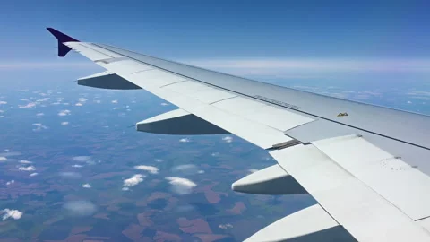 Airplane wing view out of the window on the cloudy sky The Earth background. Video stock 114303047