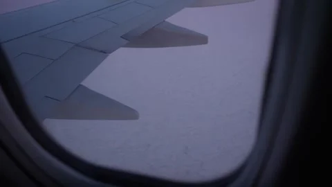 Airplane wing view over clouds during twilight, soft colors and serene 库存影片 328916080