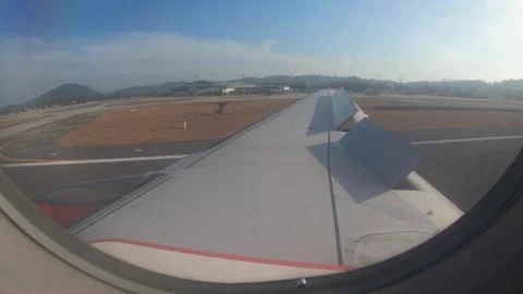 Airplane Wing View from Passenger Window During Takeoff or Landing Video stock 310377985