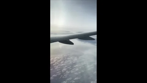Airplane Wing View From Passenger Window Flying Above the Clouds. Cloudy Mo.. Stock Footage 339295577