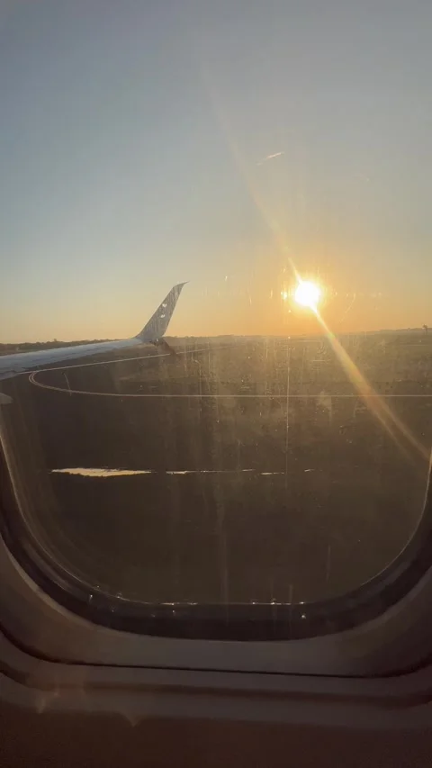 Airplane wing view from passenger window during a golden hour flight. Stock Footage 340429285