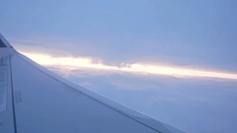 Airplane Wing View of Sunset Clouds During Flight Stock Footage 268651026