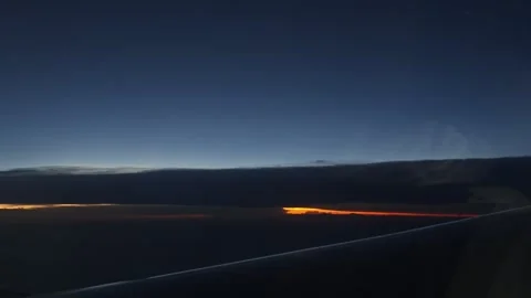 Airplane Wing View of Twilight Sky with Orange Sunset Glow Under Thick Clouds Stock Footage 340476143