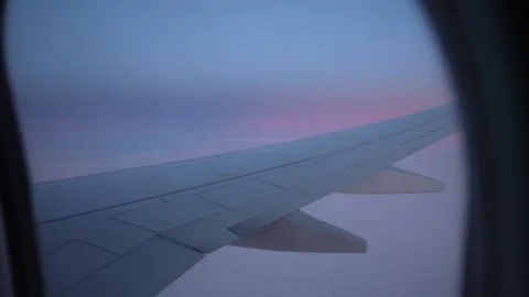 Airplane wing view from window during flight at sunset over clouds Stock-Footage 328916142