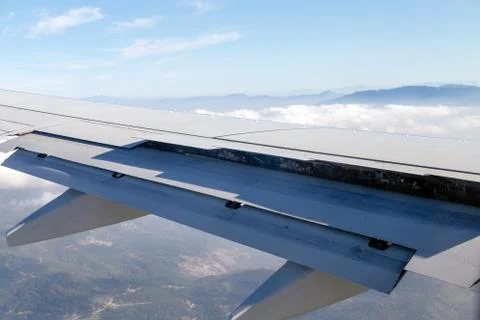 Airplane wing while breaking during landing Stock Photos