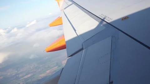 Airplane wing from window with beautiful clouds and turning during flight Stock Footage 45070864