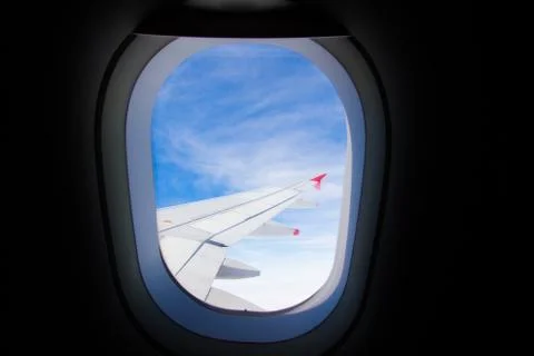 Airplane wings through the window Stock Photos