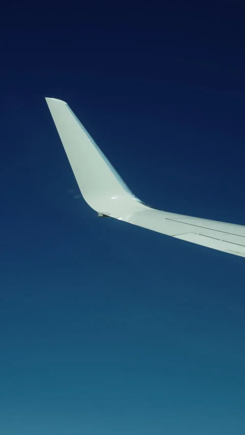 Airplane wingtip against deep blue sky in flight Stock-Footage 347965983