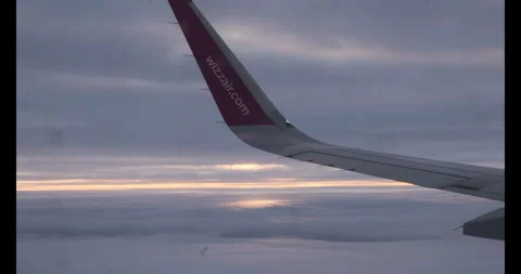 Airplane wingtip dark sky over clouds. Iluminator perspective 스톡 동영상 265487018