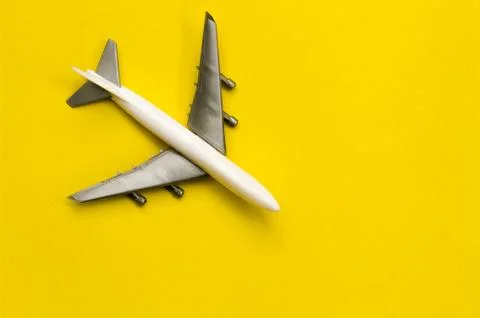 Airplane on yellow background with space for text. The concept of travel or v Foto stock