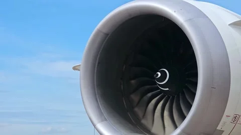 Airplane's jet engine was spinning at idle speed with blue sky background. Stock Footage 252586713