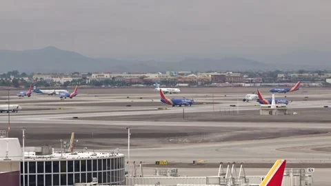 Airplanes in queue holding short waiting delays at harry reid las vegas airport Stock Footage 257703229