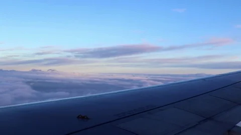 Airplane's wing in the air, flying, sunset sky Stock Footage 78010441