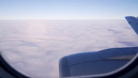 Airplane's wing and engine in flight. Airplane window view. Slow clouds movement Stock Footage 82227282