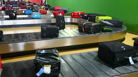 Airport Baggage Claim Carousel with suitcases waiting for passengers Stock Footage