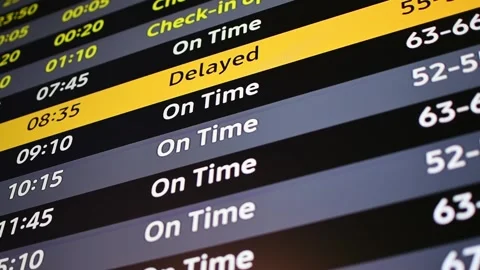 Airport departure board changes flight status from on time to delayed, warning Video stock 337664060