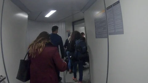 Airport Exit Gate Corridor With Passengers POV Stock Footage 99256342