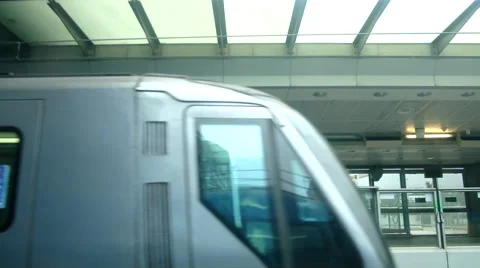 An airport express train pulls into a station stop in Hong Kong, China Video stock 47576692