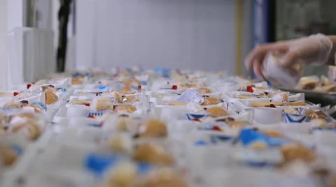 In airport factory the woman is packing lunch boxes with food Stock Footage