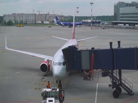 Airport, the gangway approaches the airplane on the terminal. Stock Footage