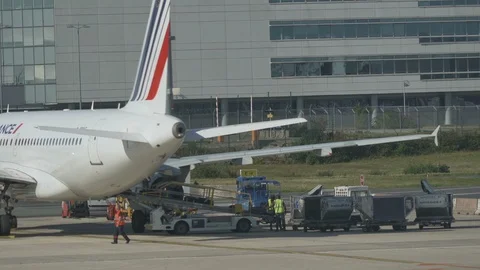 Airport ground support - workers move luggage from belt to luggage cart v3 Stock Footage 119831025