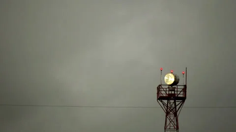 Airport light beacon stormy skies Stock Footage