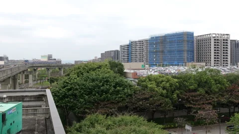 Airport MRT commuter train on elevated viaduct near Taoyuan HSR Station A18 Stock Footage 336460314