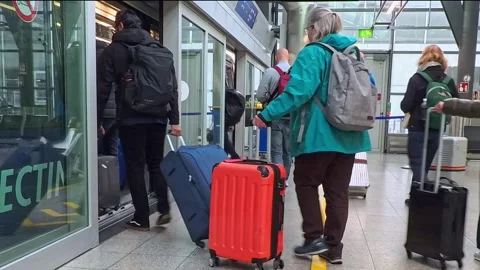 Airport passengers boarding a shuttle train at the Frankfurt Airport, Germany Stock Footage 321244541