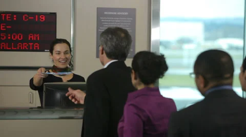 Airport passengers check in at ticket counter Stock Footage