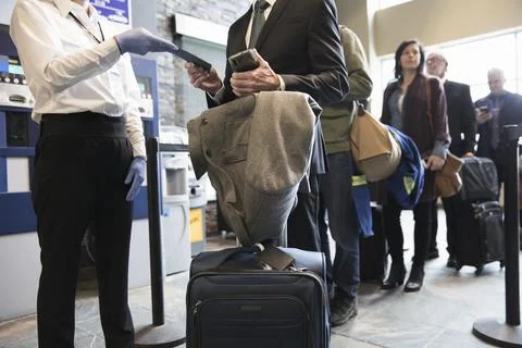 Airport security agent checking boarding passes Foto stock