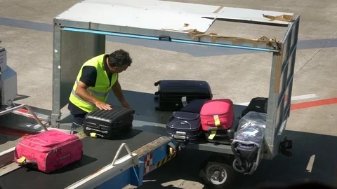 Airport staff loading luggage in a Stock Video Pond5