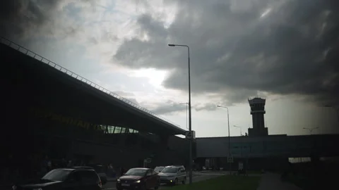 Airport terminal and dispatch tower under cloudy sky Stock Footage 324914889
